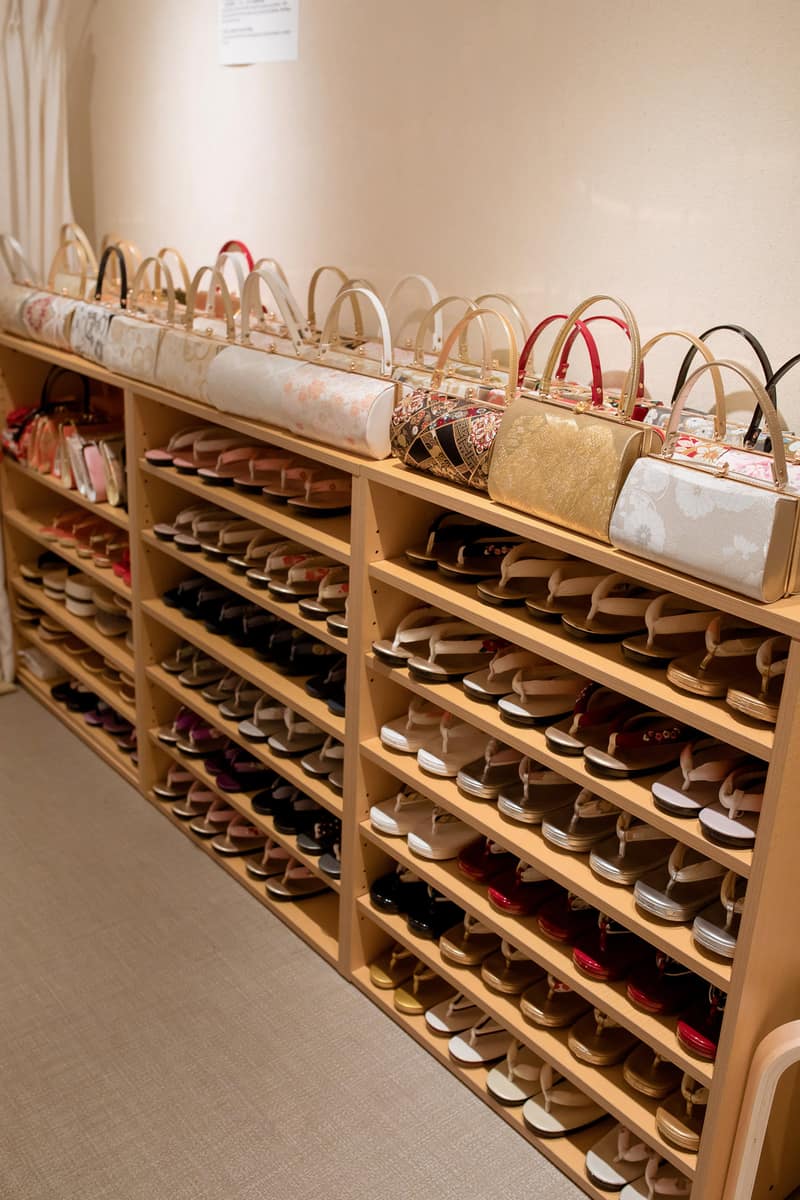 Shelves of zori sandals arranged by size, with matching bags lined up on top